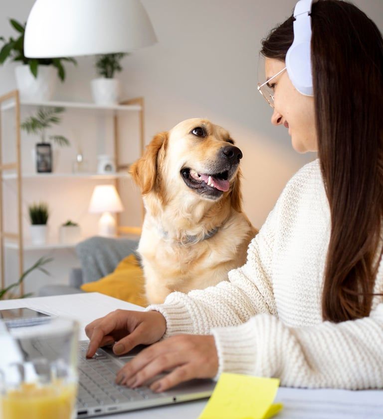 A woman learning online with her golden retriever beside her